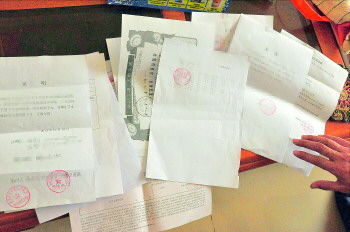 60歲的市民仇先生為了辦理公證所需的這些證明材料,半個(gè)月時(shí)間里跑了30多趟腿。記者　李萌博　攝