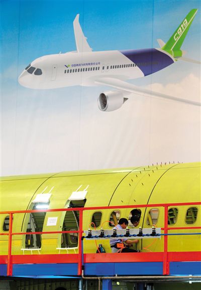 昨日，中國商飛總裝制造中心技術(shù)人員對接C919首架機(jī)的機(jī)體。新華社記者 丁汀 攝